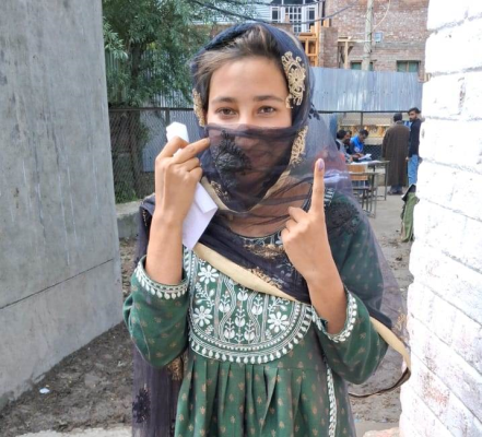 Neelofar,a  first time voter,showing her inked finger after casting her vote for the first time